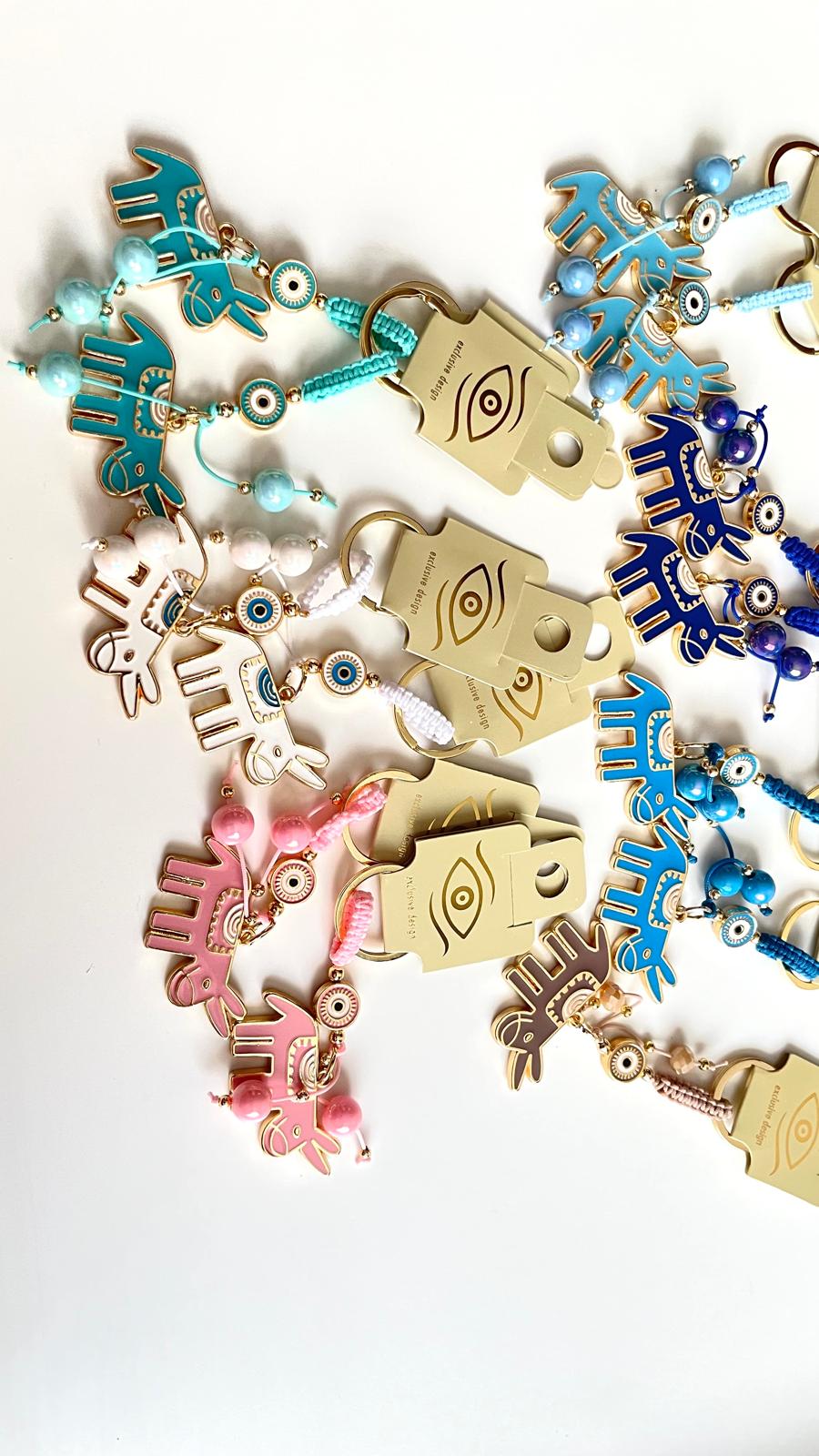 Llavero de ojo turco dorado con diseño de burro turquesa