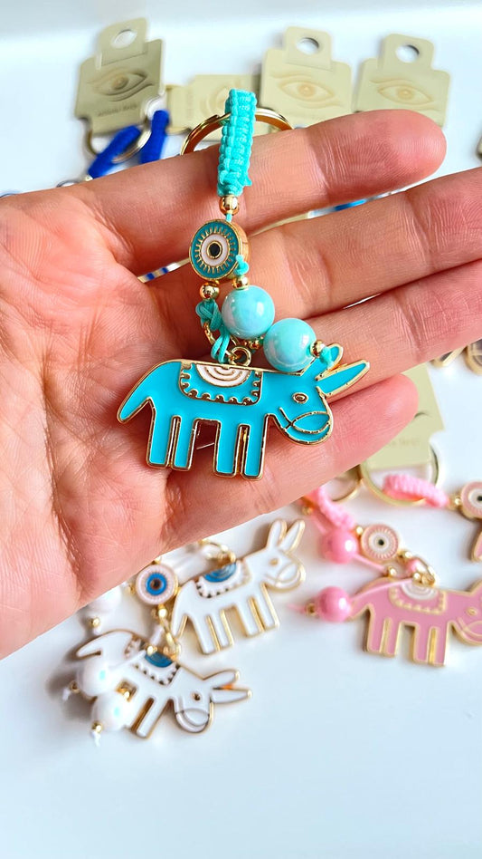 Llavero de ojo turco dorado con diseño de burro turquesa